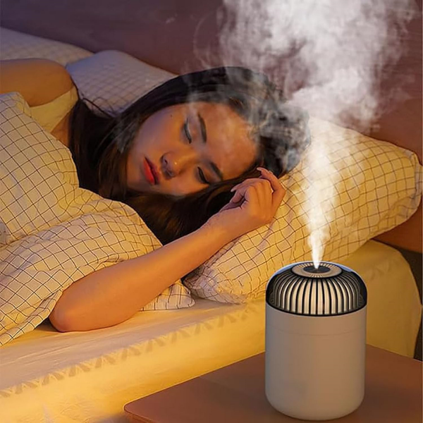 woman sleeping with Dreamzy Diffuser by her side